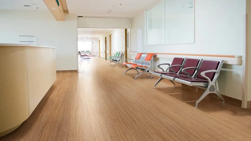 Colorful waiting chairs in a bright hospital corridor with wood-tone vinyl flooring
